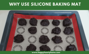 A sheet pan lined with silicone baking mat with chocolate cookies.
